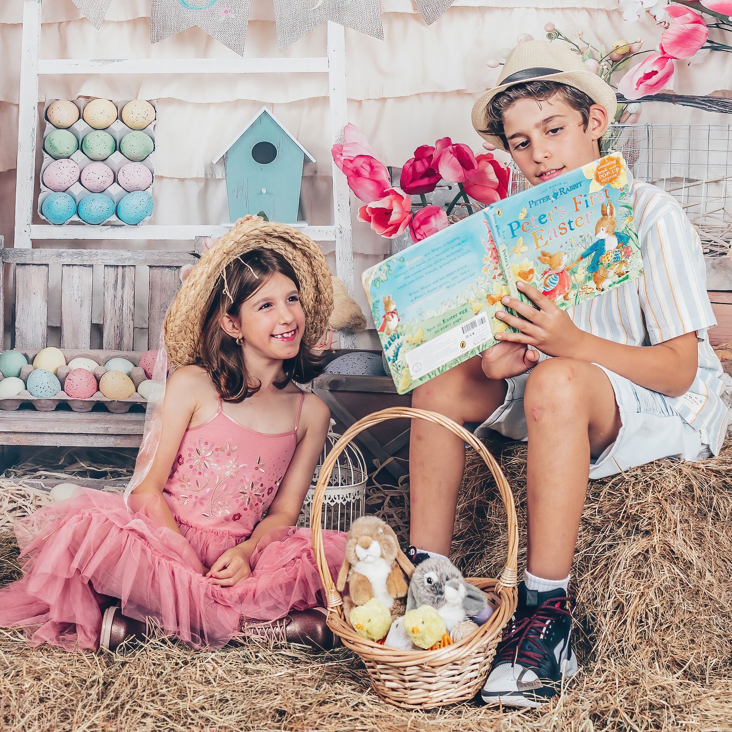 Two children sharing an Easter storybook during a styled seasonal session