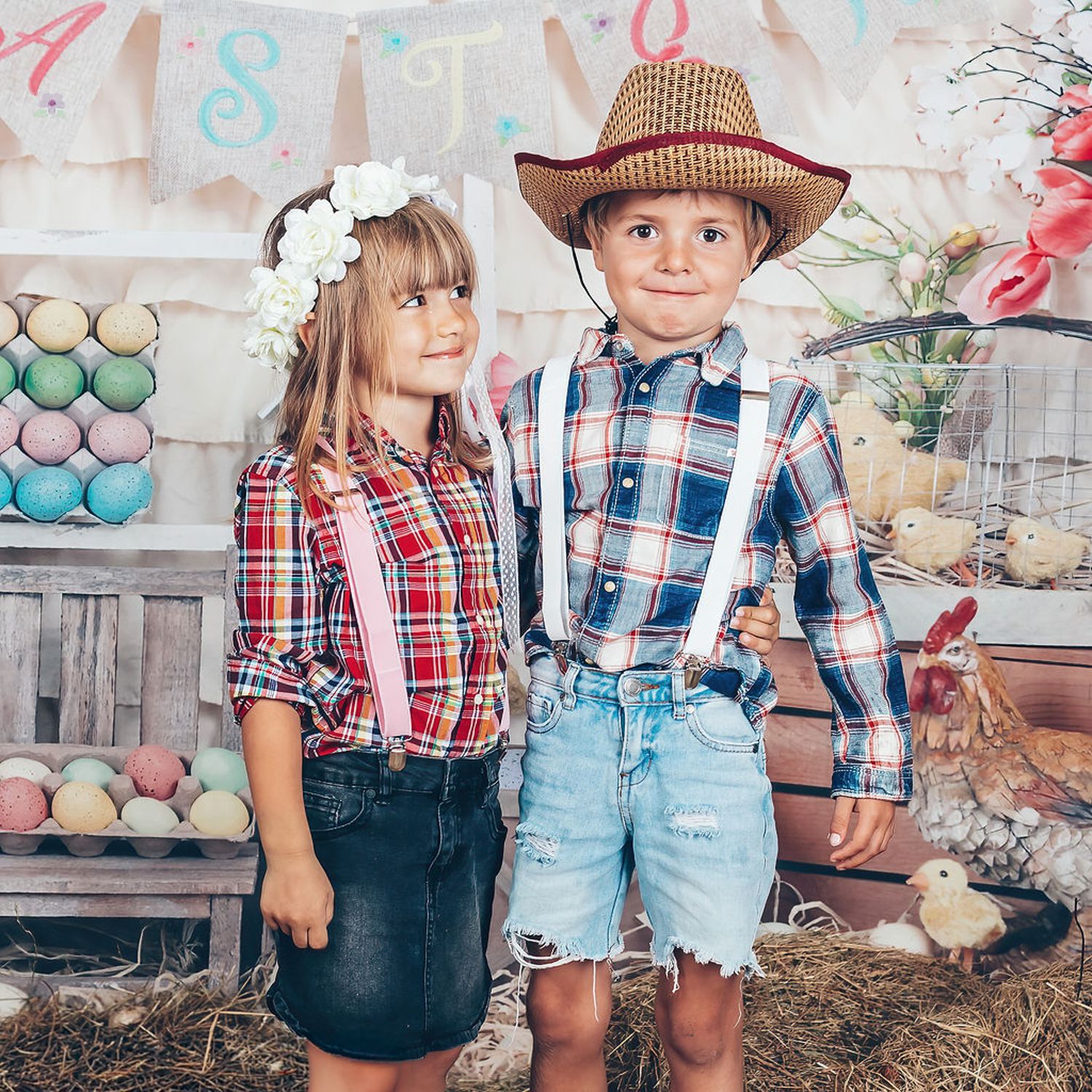 Two children in playful Easter outfits posing together in a colourful seasonal set