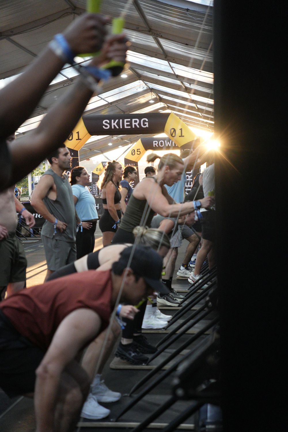 Athletes competing at the Hyrox SkiErg station during race, capturing endurance, functional fitness, and high-energy competition.
