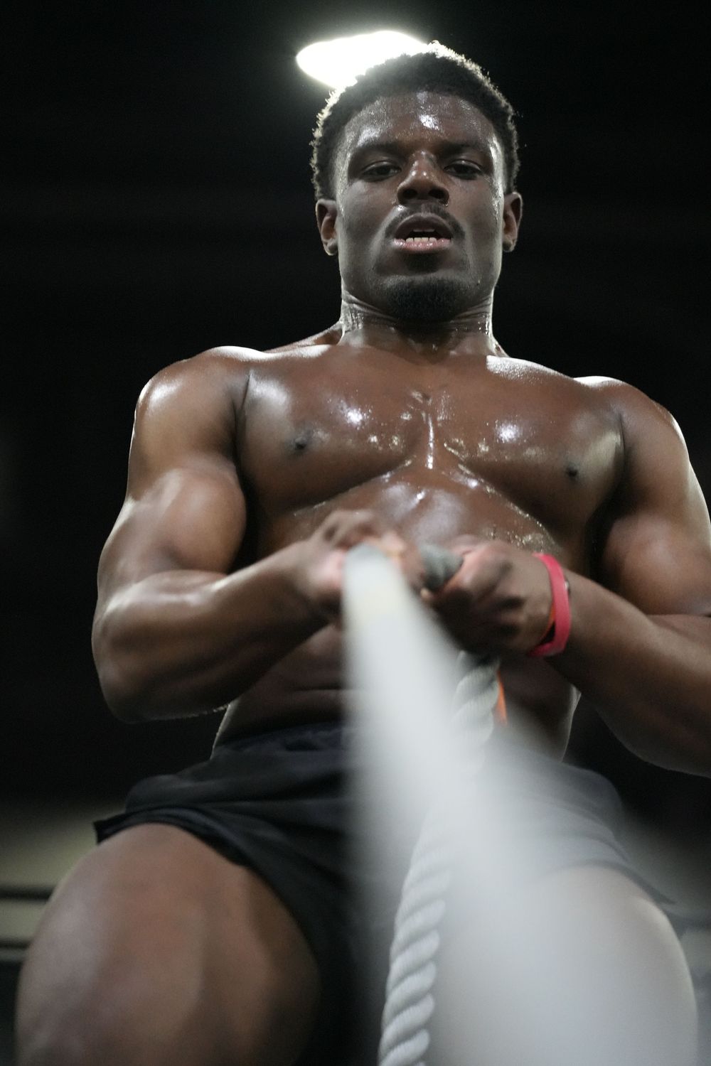 Close-up of a Hyrox athlete during sled pull, highlighting strength, endurance, and intensity in elite fitness competition.