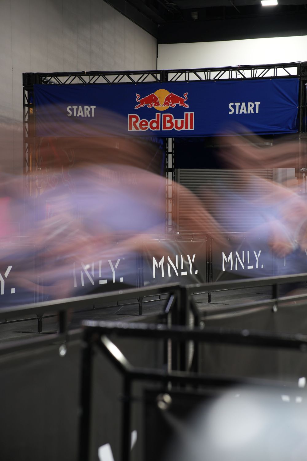 Long exposure photograph capturing athletes launching from the Hyrox start line, conveying speed, intensity, and the energy of competition.