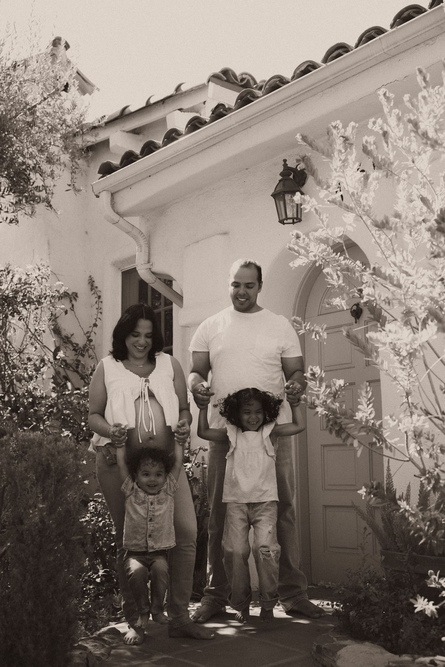 Family of four smiling during their orange county family photo session.