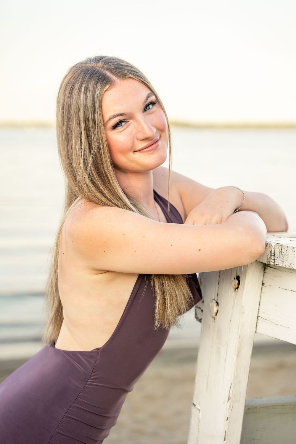 MD highschool senior photos at Rocky Point Beach. Posing on a lifeguard stand
