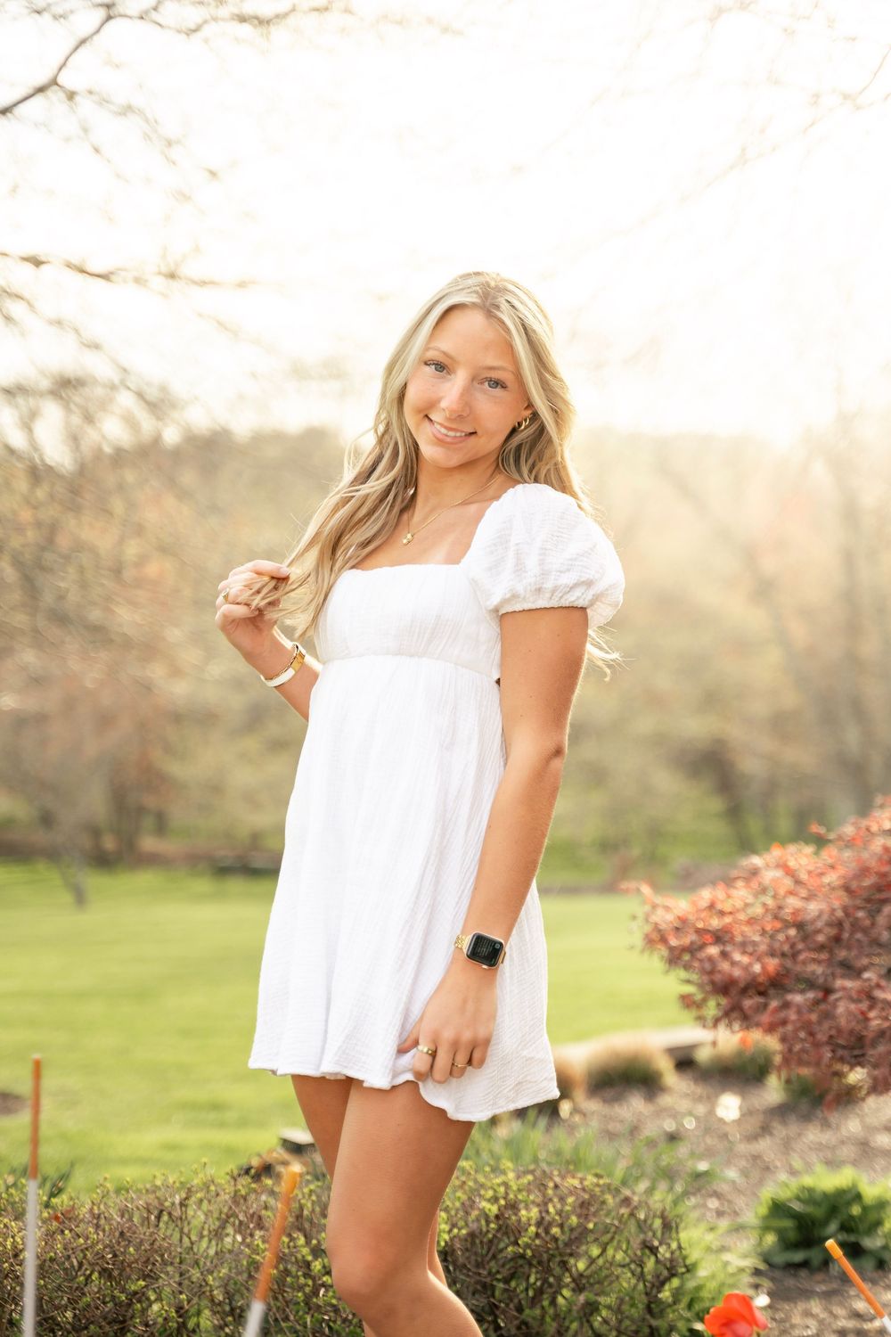 John Carroll School graduate, senior photos. Senior wearing a white graduation dress