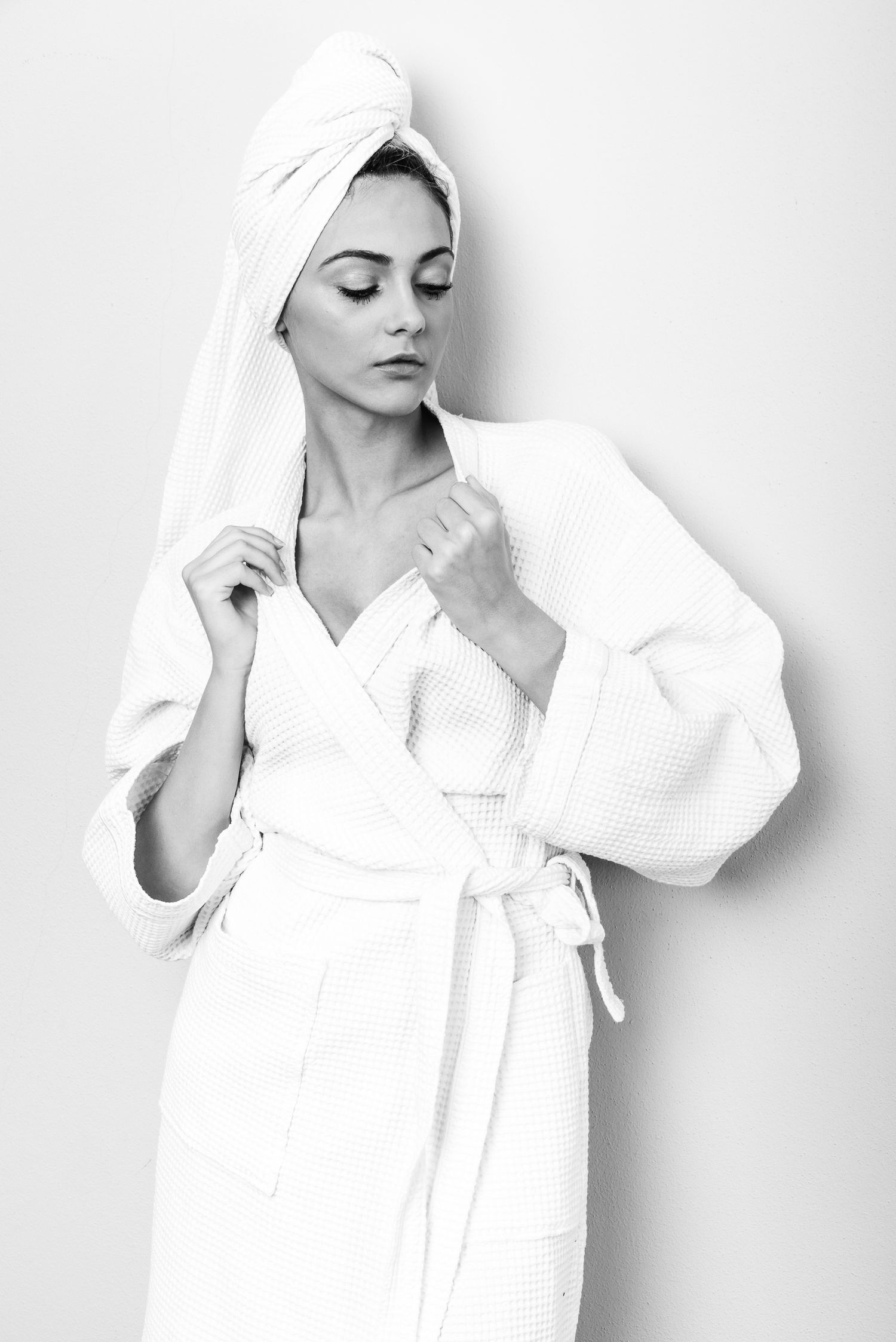 Ritratto in bianco e nero in stile editoriale avvolto in un telo da bagno caratterizzato da un'estetica intima ispirata alla serie towels