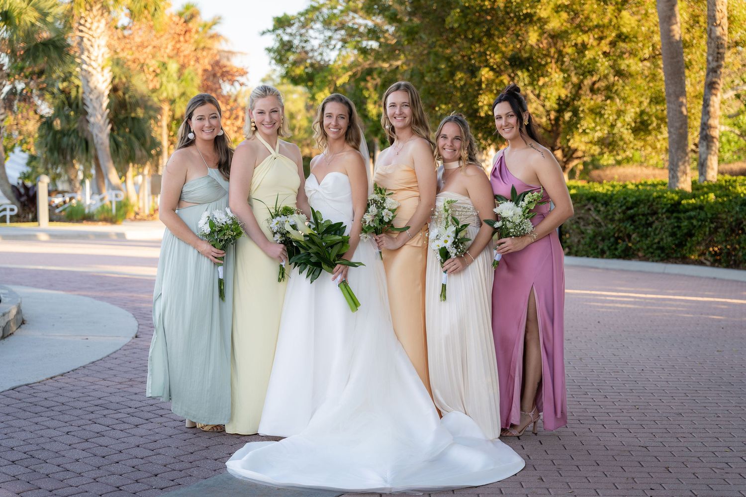Bride with her bridesmaids in the shaded driveway at the Mansion at Tuckahoe