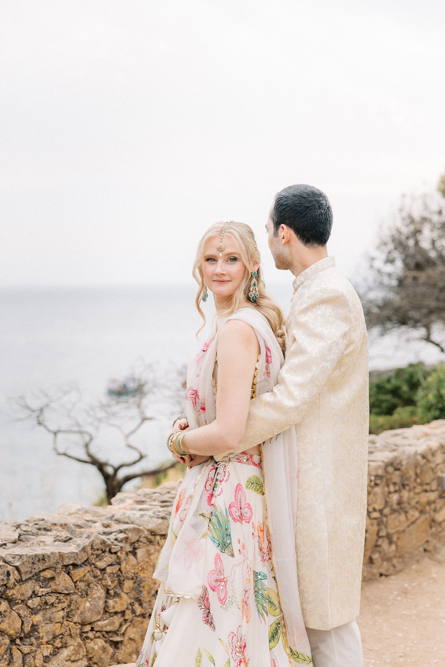 Bride and groom during their Mehndi celebration overlooking the Atlantic Ocean at Casa da Guia in Cascais, Portugal.