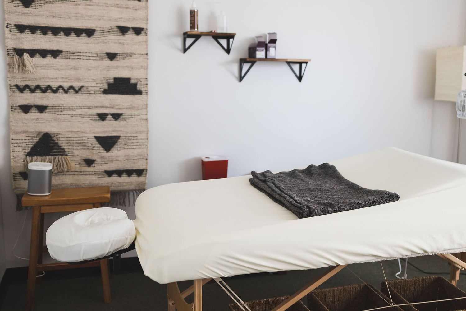 Maple Valley Acupuncture clinic interior photos of treatment room with table, chair, lamp, wall decor, foot heat lamp