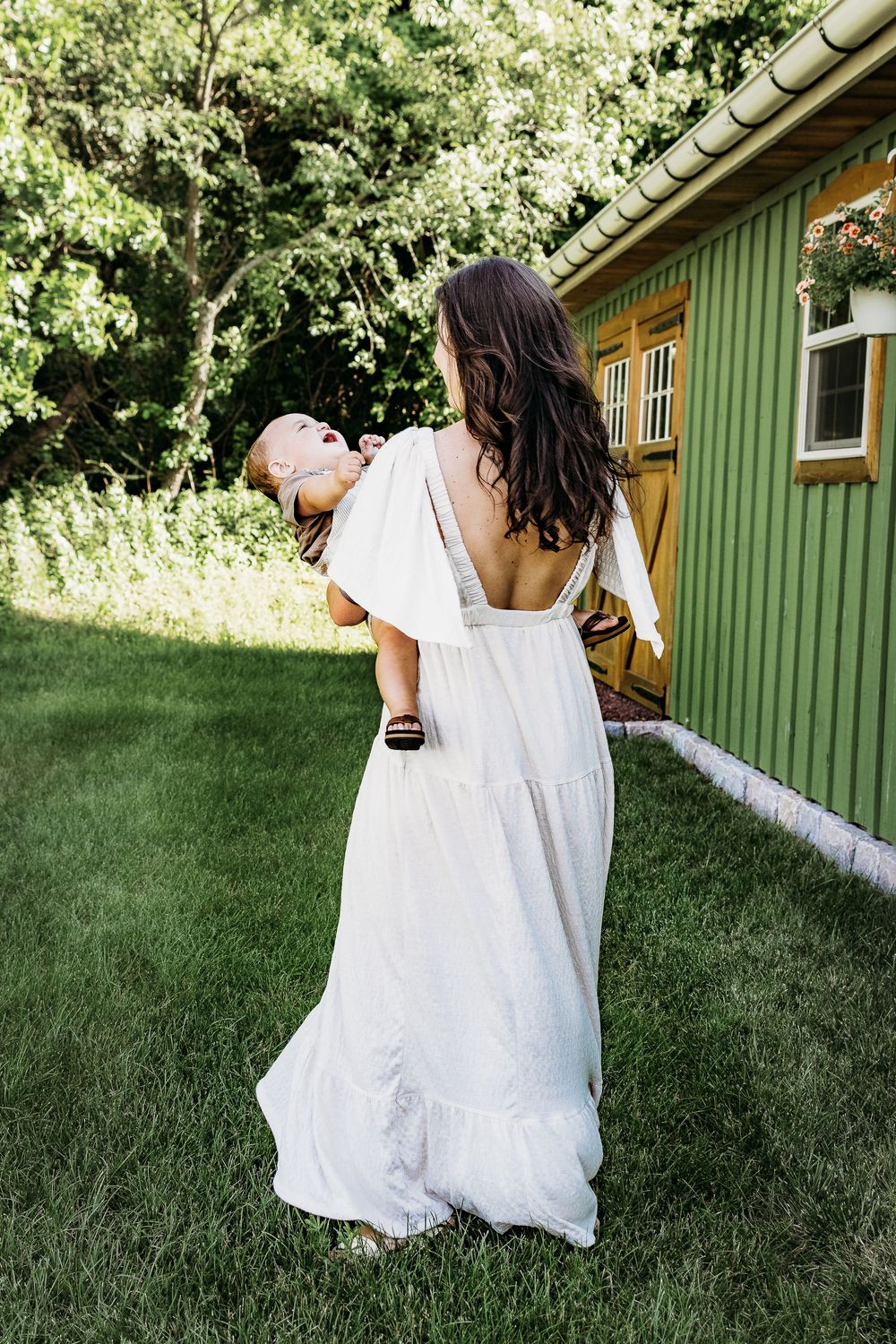 Mom carrying her young child during a candid South Jersey family photo session.