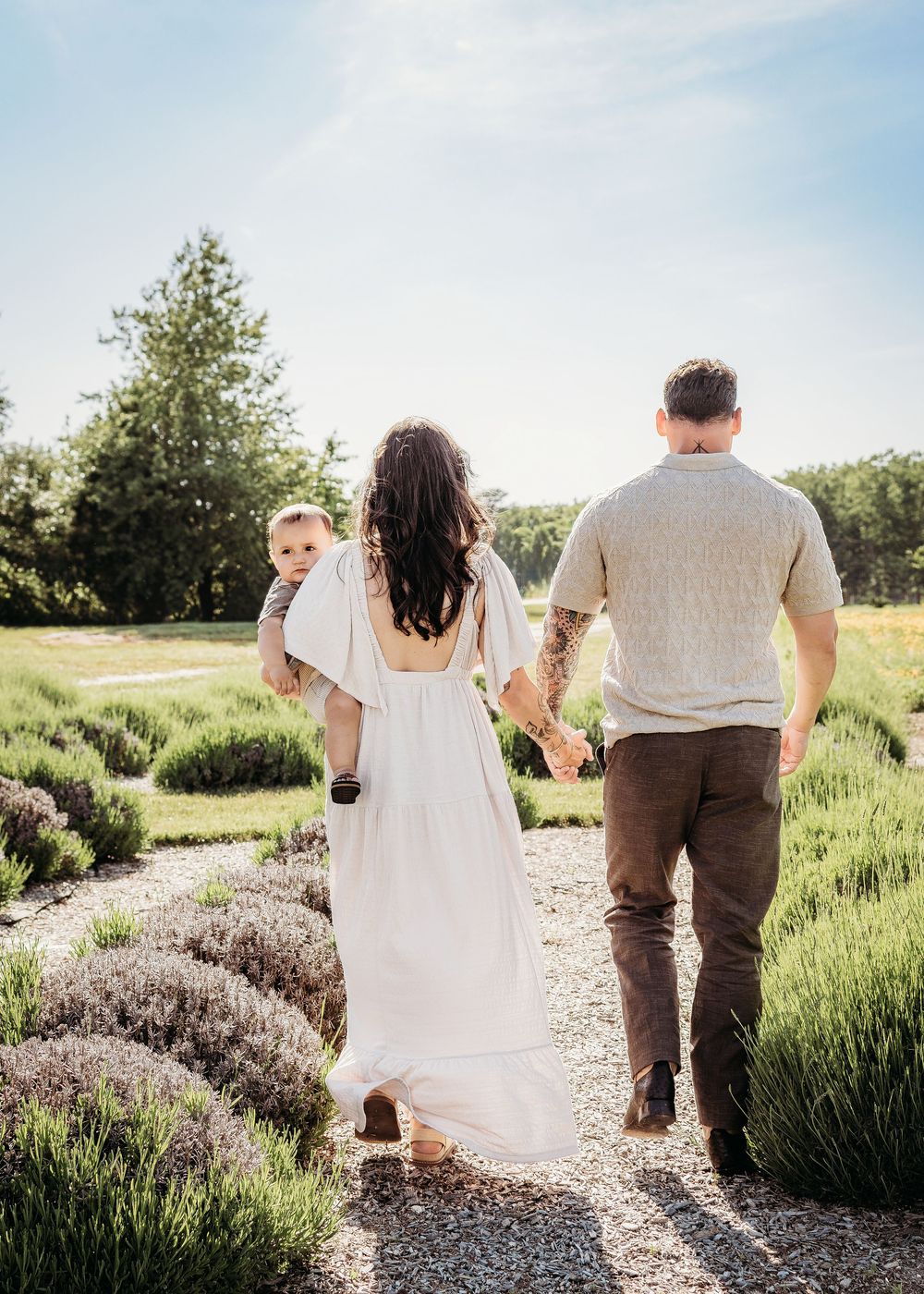 Family walking together through a lavender field during a Berlin, NJ family photo session.