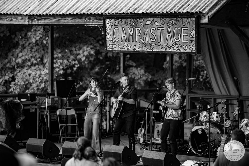 Band performing live on Camp Stage outdoors in black and white photo.