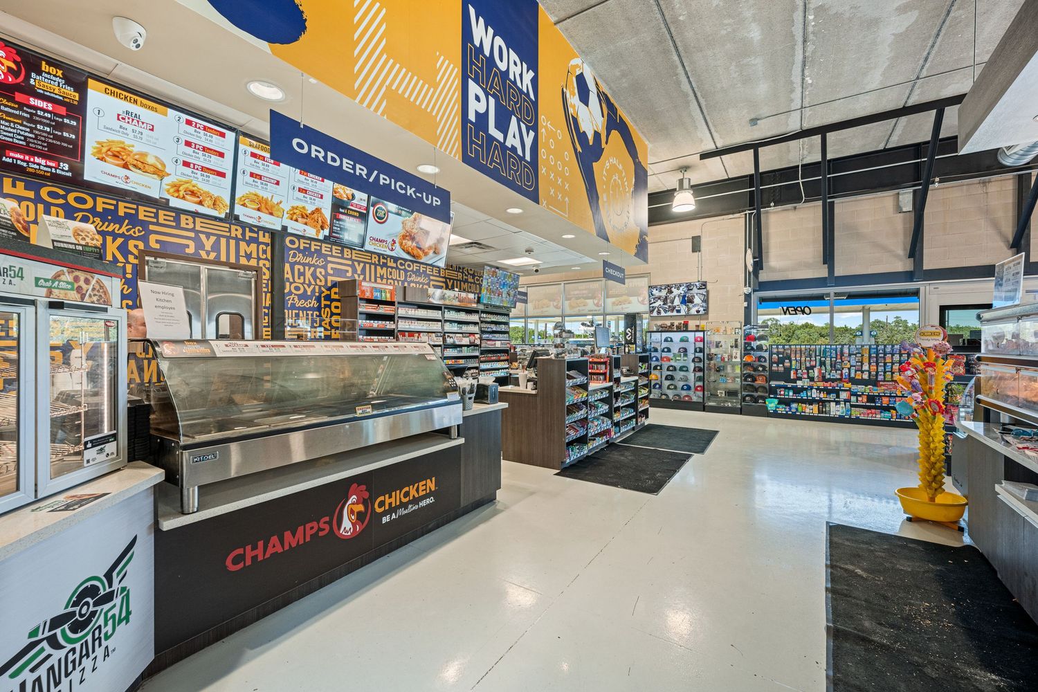 Interior of a convenience store featuring Champy's Chicken counter and retail shelves.