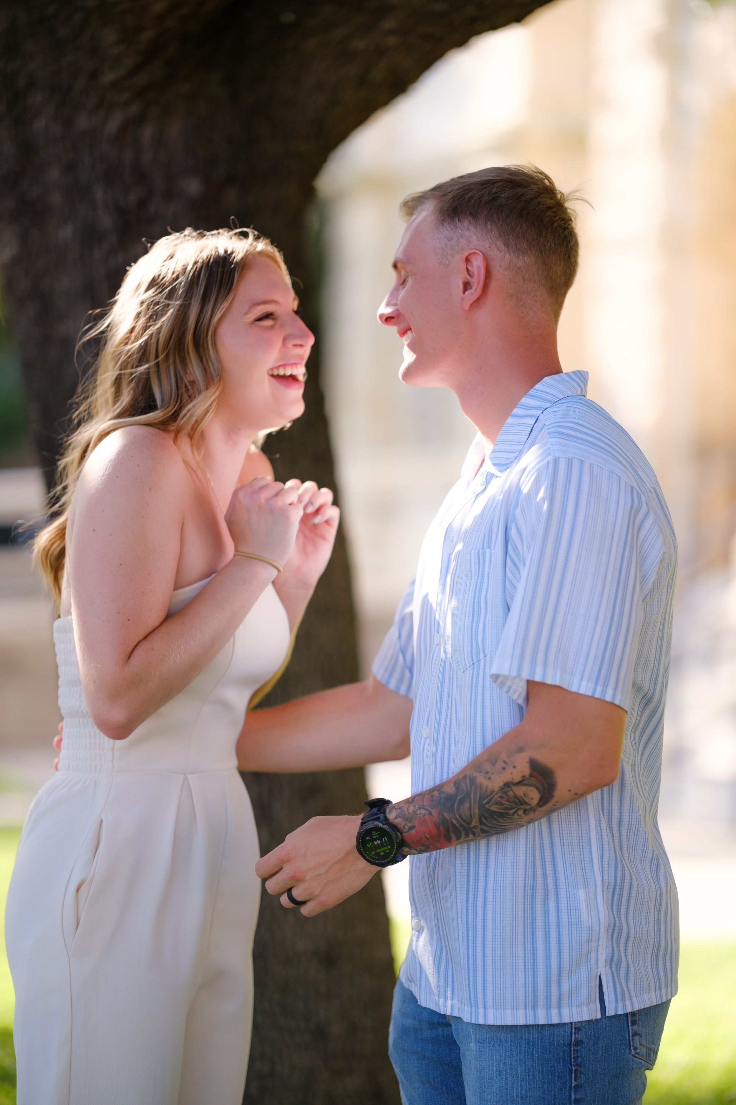 Happy newlywed couple laughing and sharing a joyful moment together outdoors in sunlight  in downtown Belton Texas
