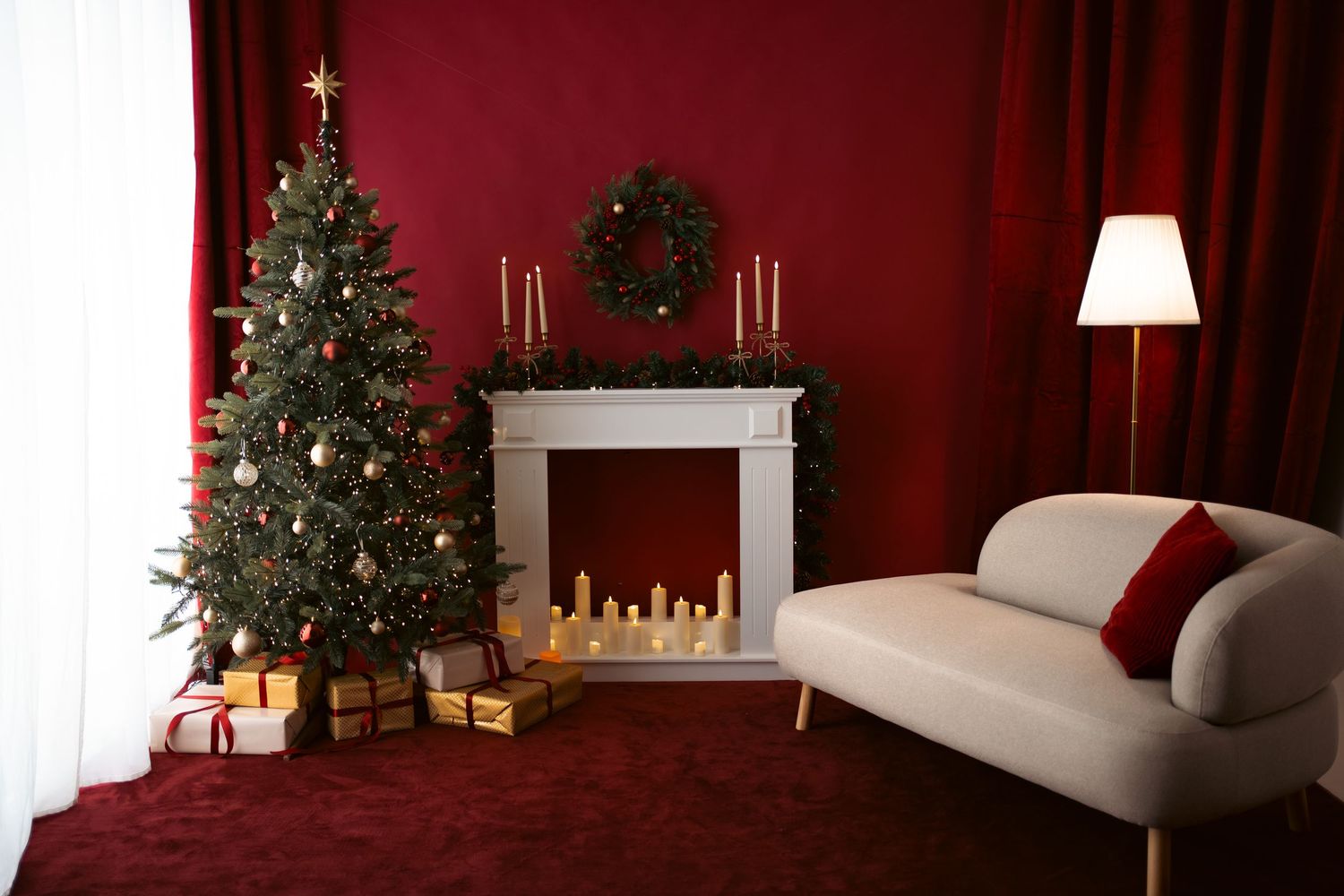 Festive Christmas scene with decorated tree, white fireplace mantel with candles, and wreath on deep red wall.