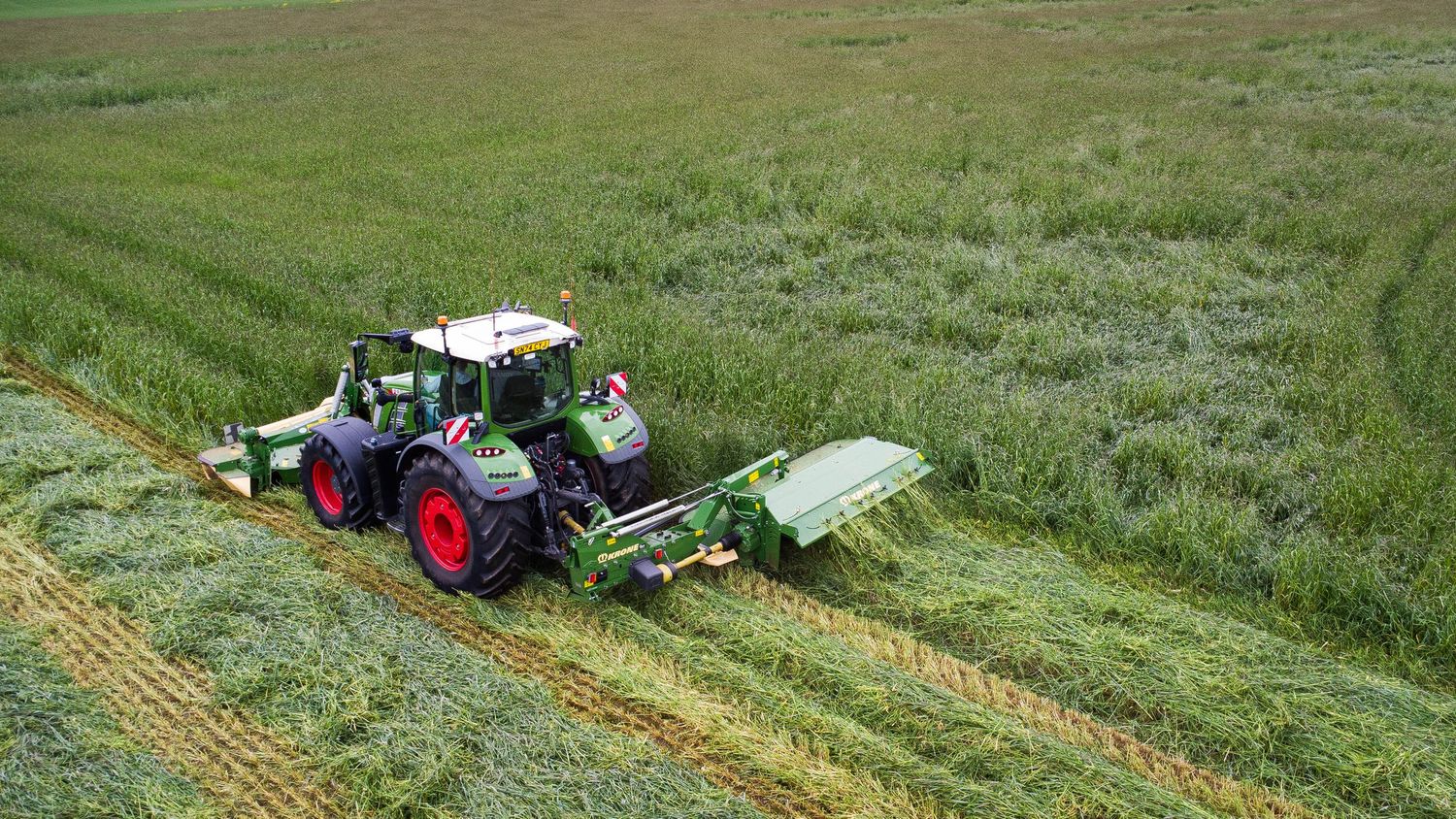 drone shot of tractor cutting silage