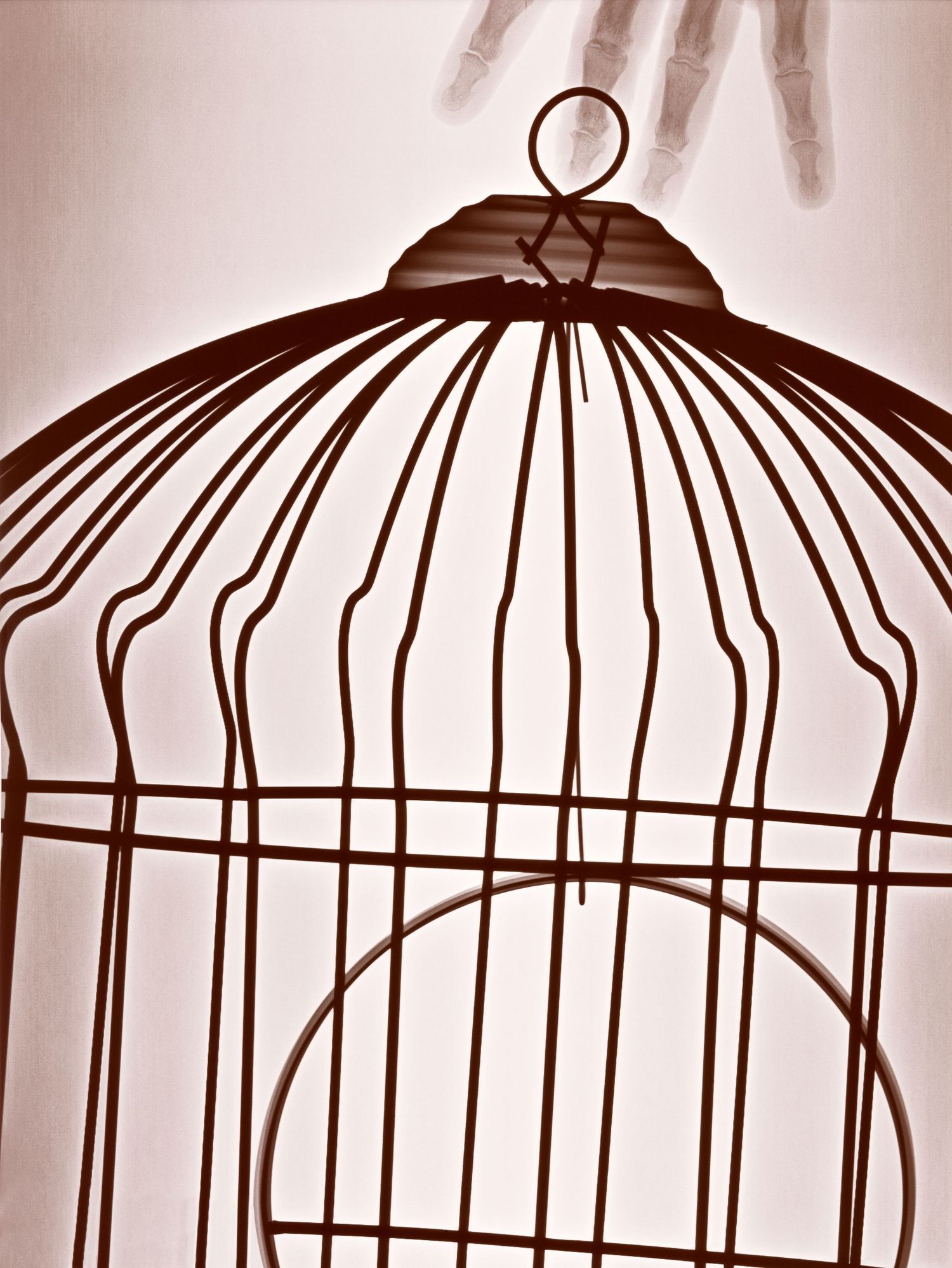 Skeletal hand holding a dark vintage birdcage against a light sepia background, symbolizing captivity and freedom.