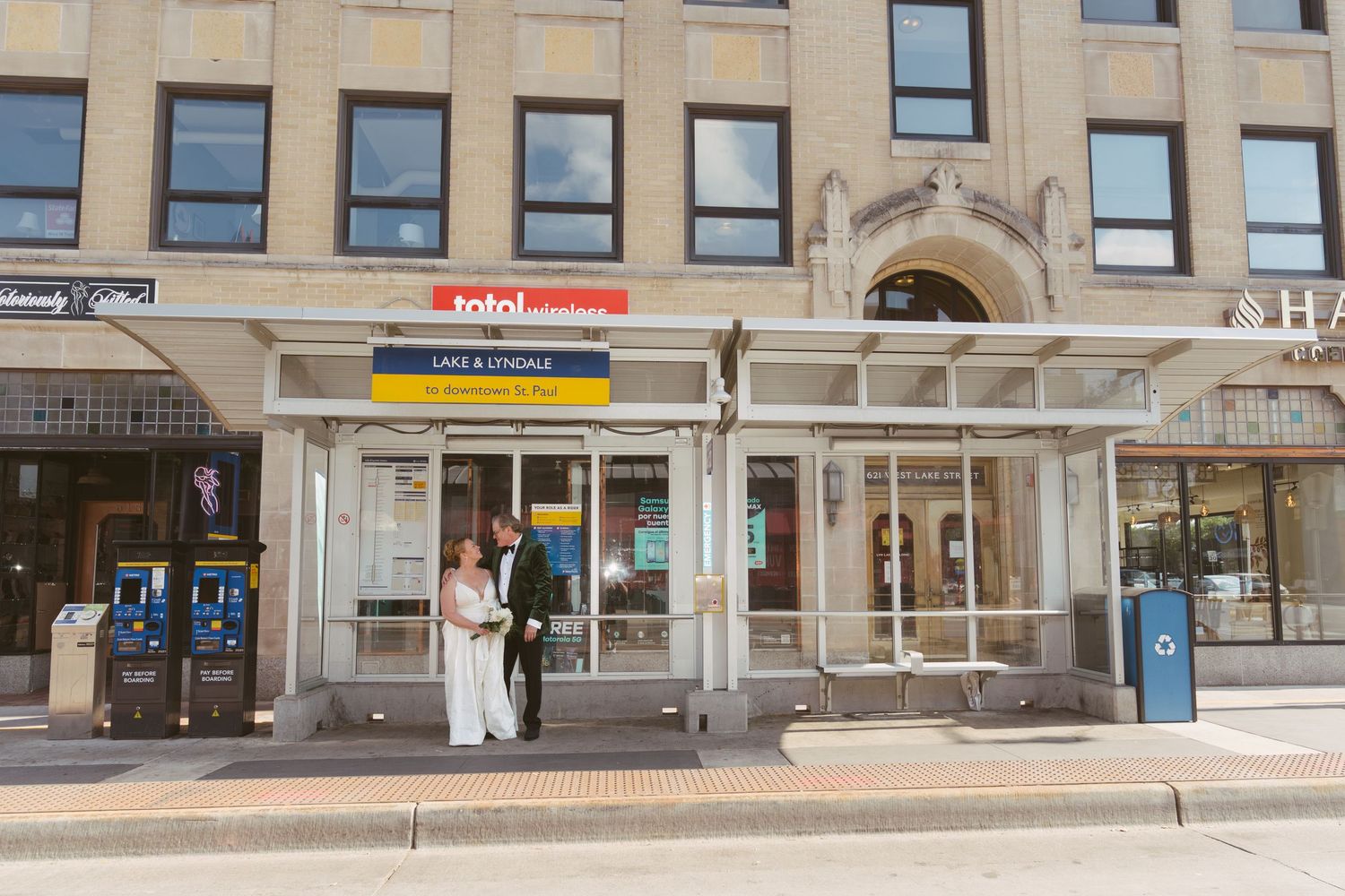Bride and groom pose together outside a Metro transit station in Downtown St. Paul on their wedding day.