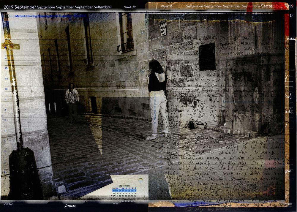 Black and white photo of a person standing near a graffiti-covered stone wall in a European alleyway, September 2019.