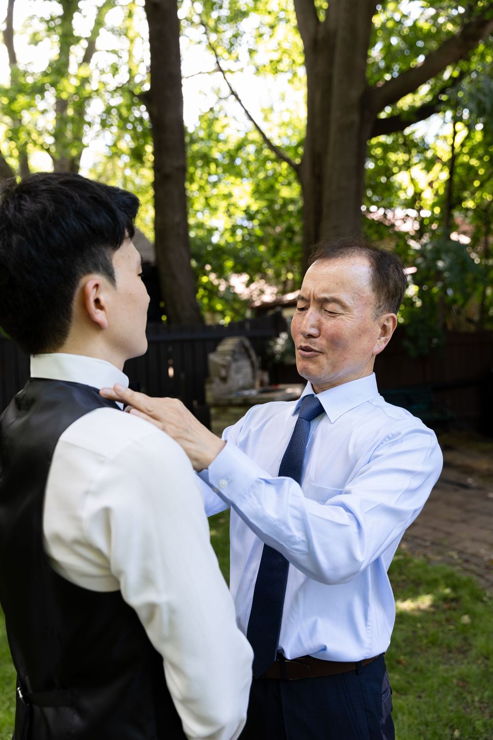 Grooms dad adjusting the grooms bowtie on the morning of their London, Ontario wedding.