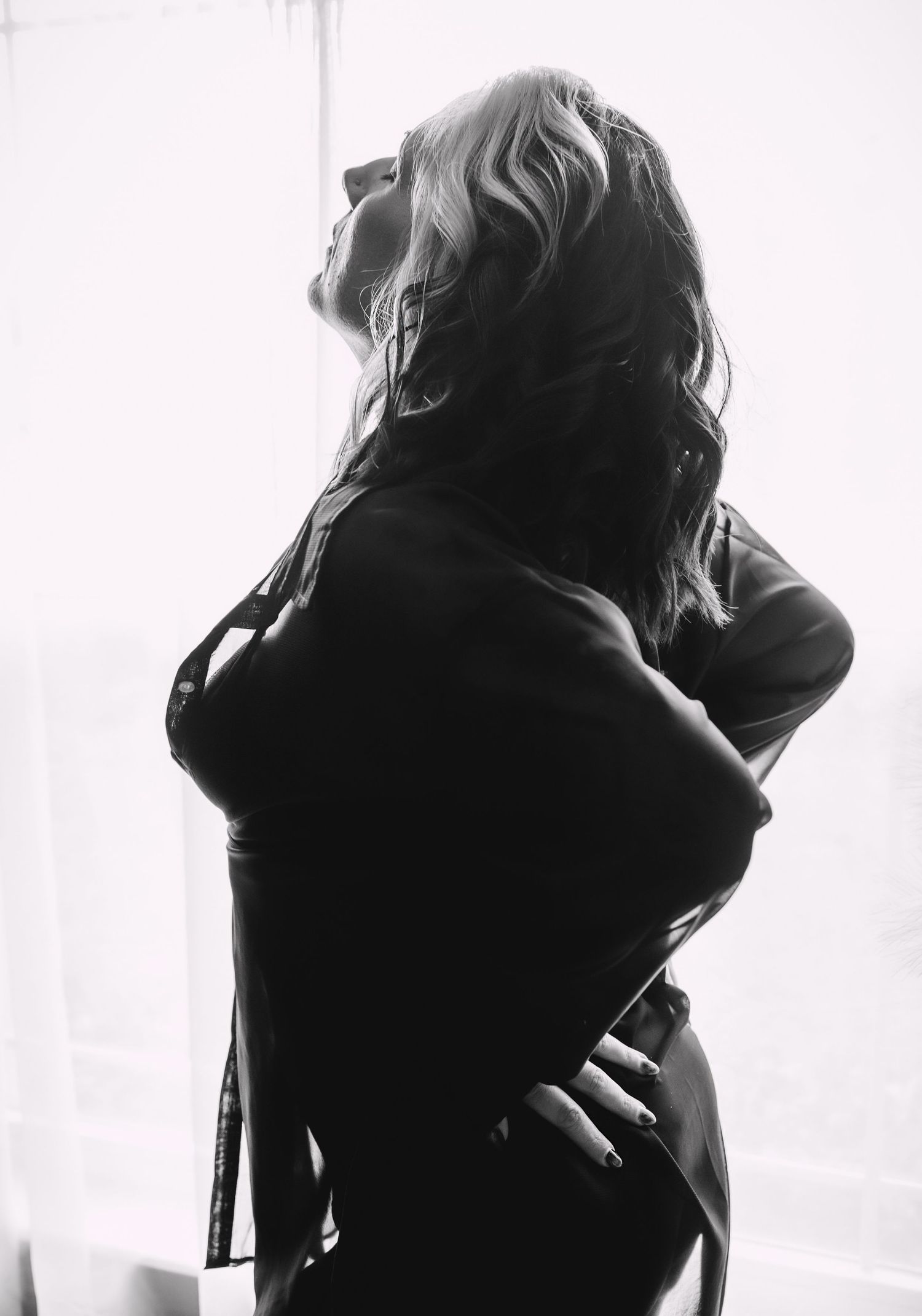 an older woman smiling during her boudoir session in brooksville florida
