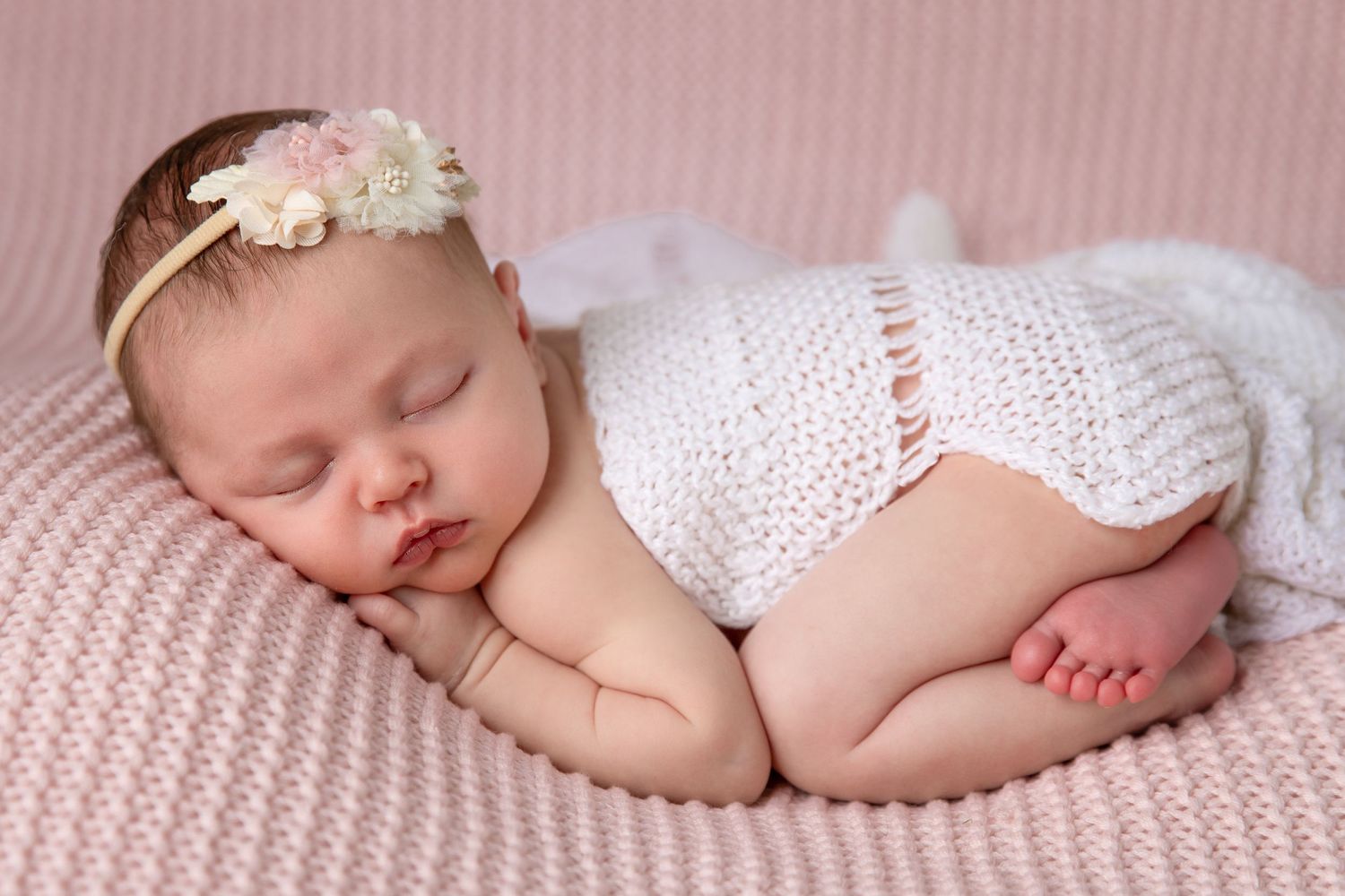 Professional posed newborn baby photoshoot in Dubai with baby gently posed on tummy