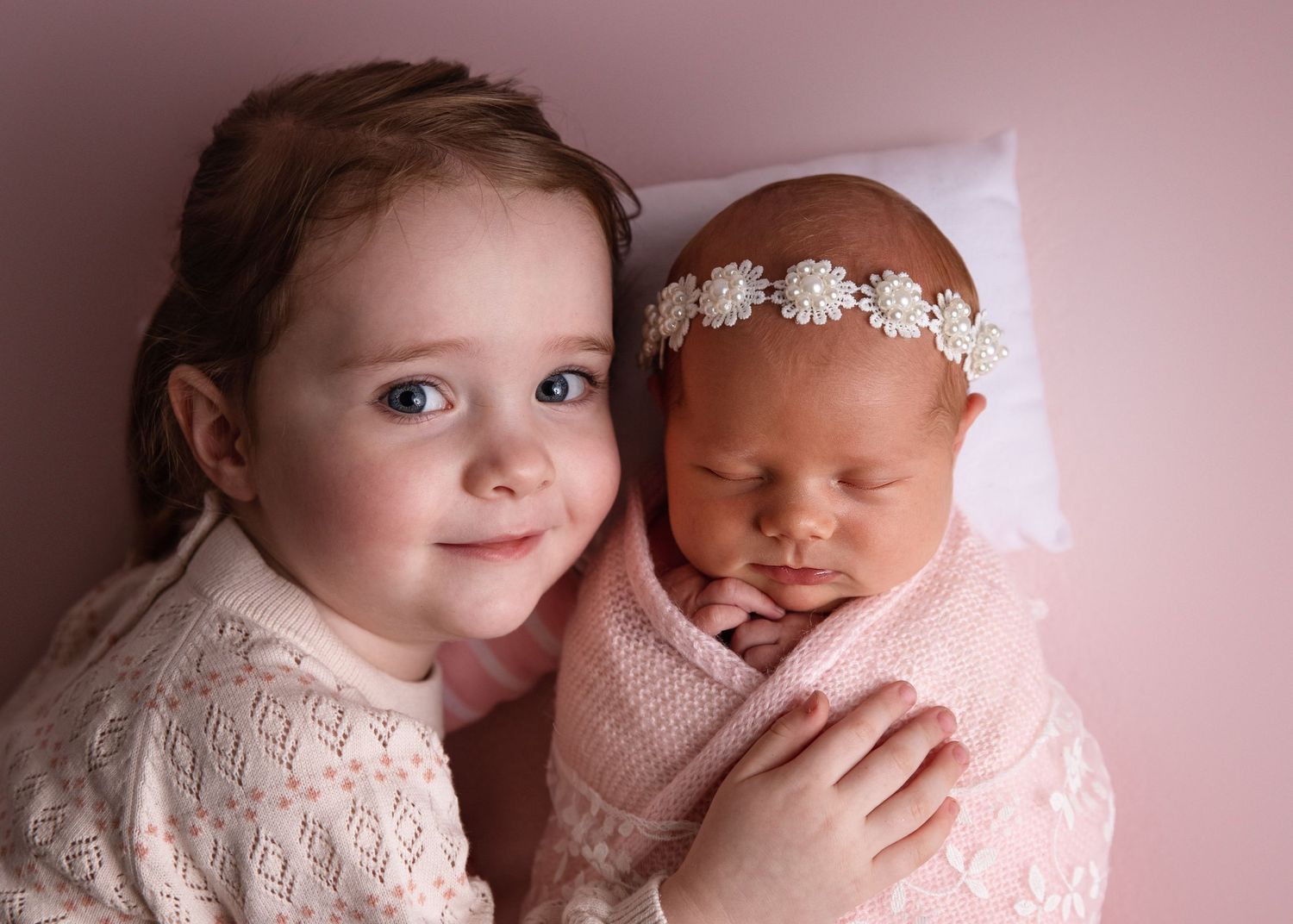 Posed newborn studio photoshoot with older sibling in Dubai