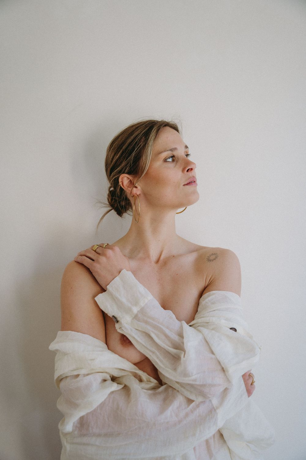 Artistic portrait series in white flowing fabric against minimal background.