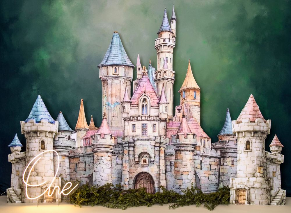 Enchanting fairy tale castle backdrop with pink and stone towers against a dreamy green sky.