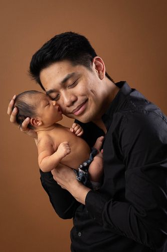A romantic couple in black attire share tender moments in a series of intimate portrait photographs against brown backdrop.