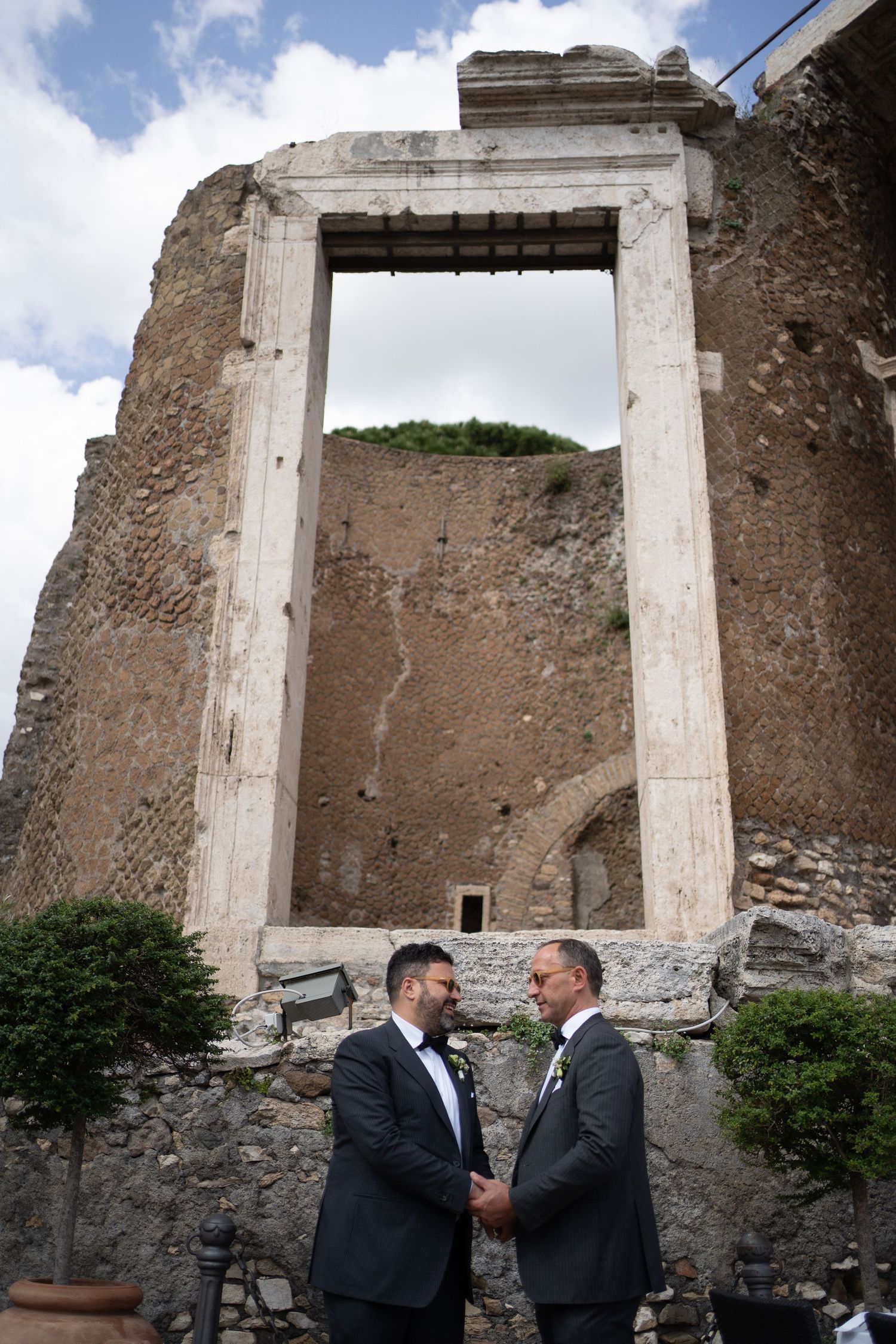 Ancient stone ruins with white doorframe against blue sky shown from multiple angles at historic archaeological site.