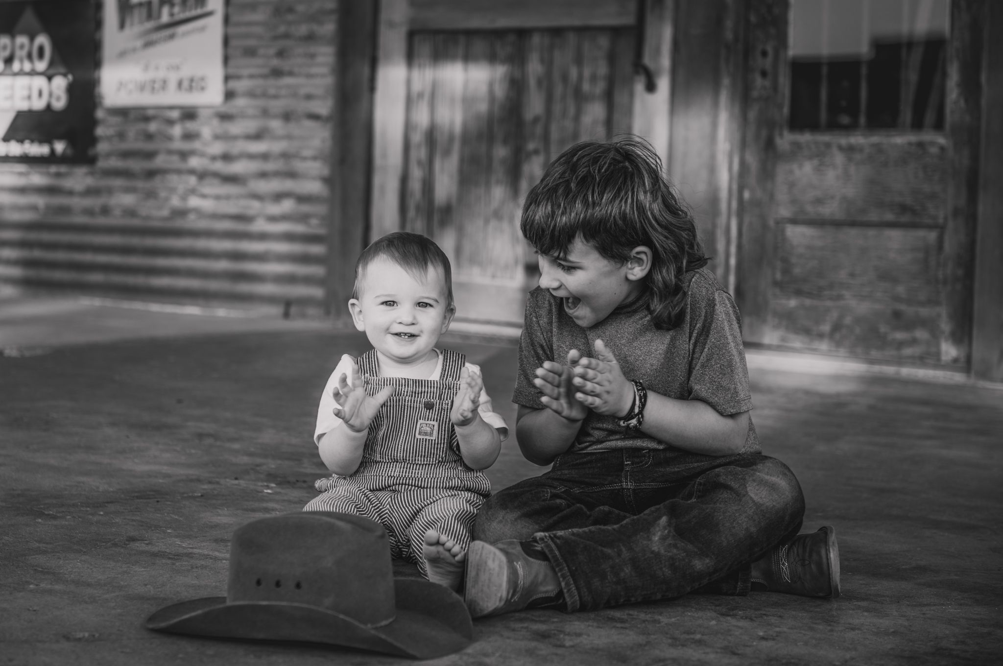 A vintage black and white photo sequence shows a child rolling playfully on the ground in front of a brick building.