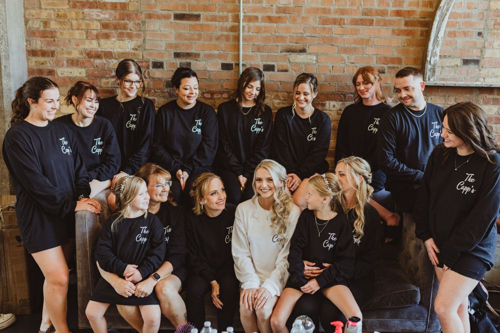 Wedding guests seated in rows at a rustic brick venue.