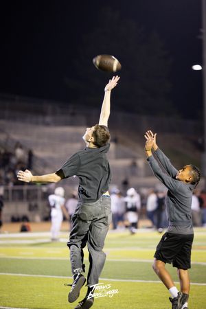 Sequence of someone doing a backflip on a football field at night.