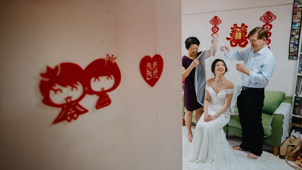 Red paper cutout decorations on wall with people visible in doorway.