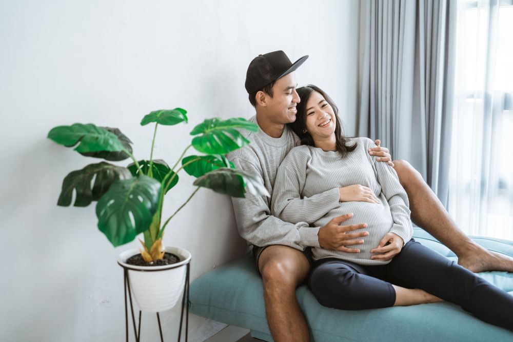 Happy couple enjoy the last days of pregnancy before wife gives birth. Happy to have maternity coverage from Smithtree