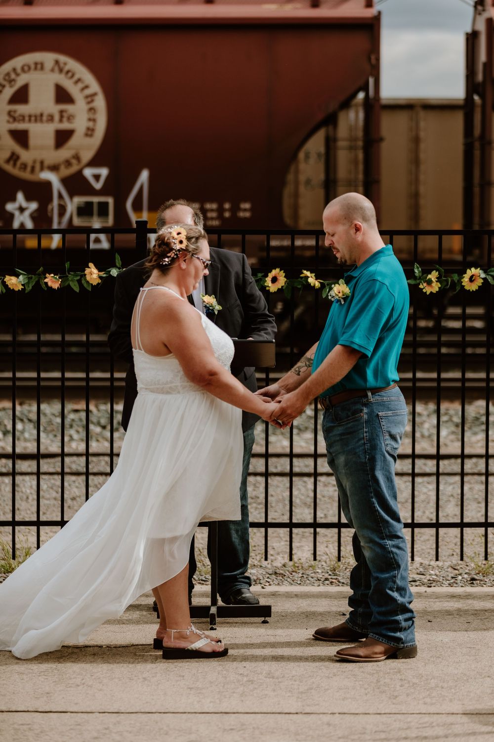 A wedding couple holds hands in front of a rustic building in a series of progressive shots.