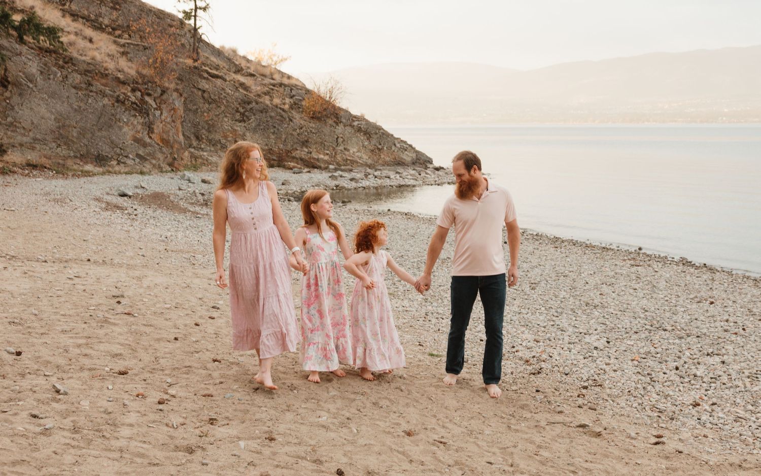 Mom and Dad on the beach with their baby at a family photoshoot in west kelowna bc