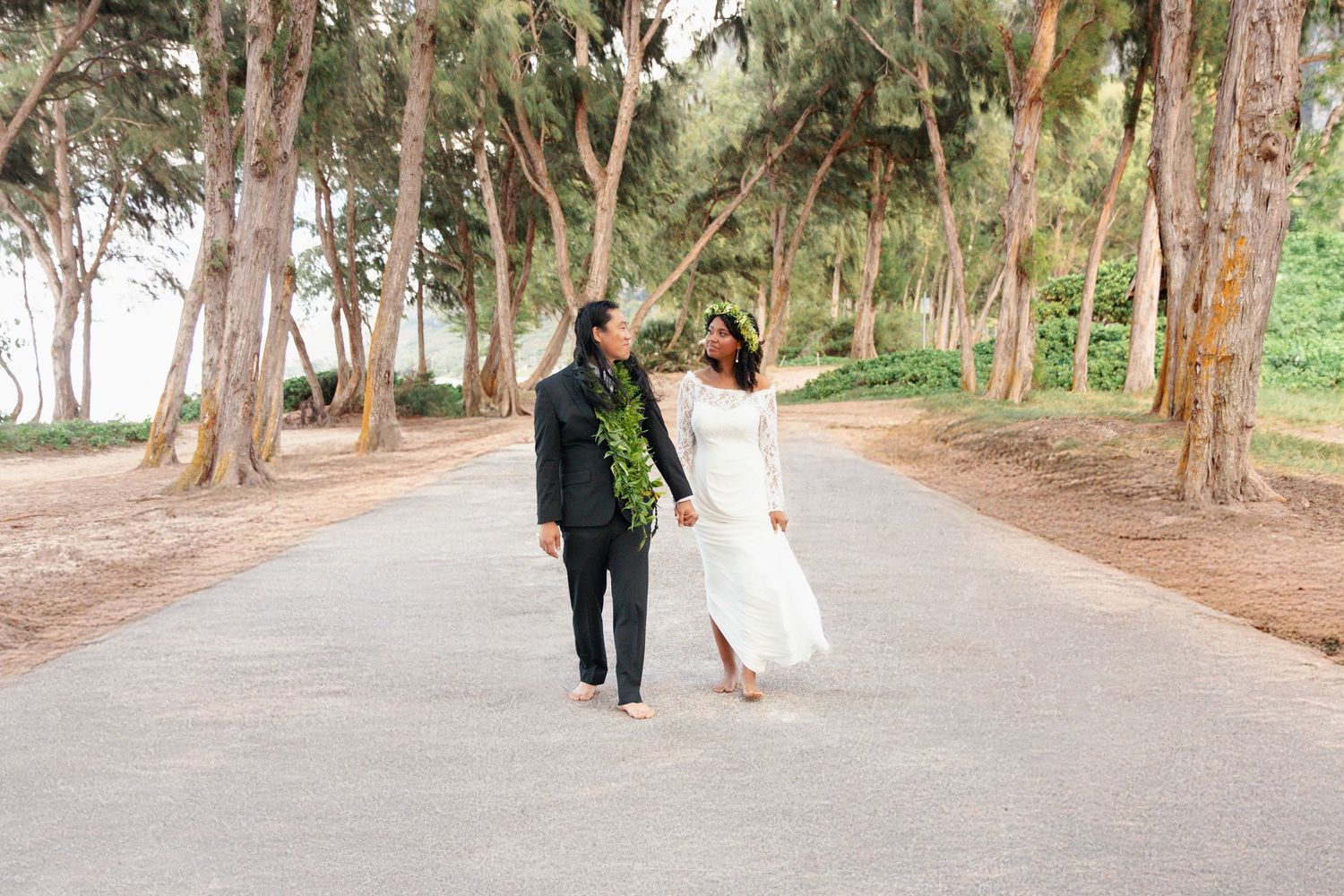 Couple walking along a scenic beach forest.