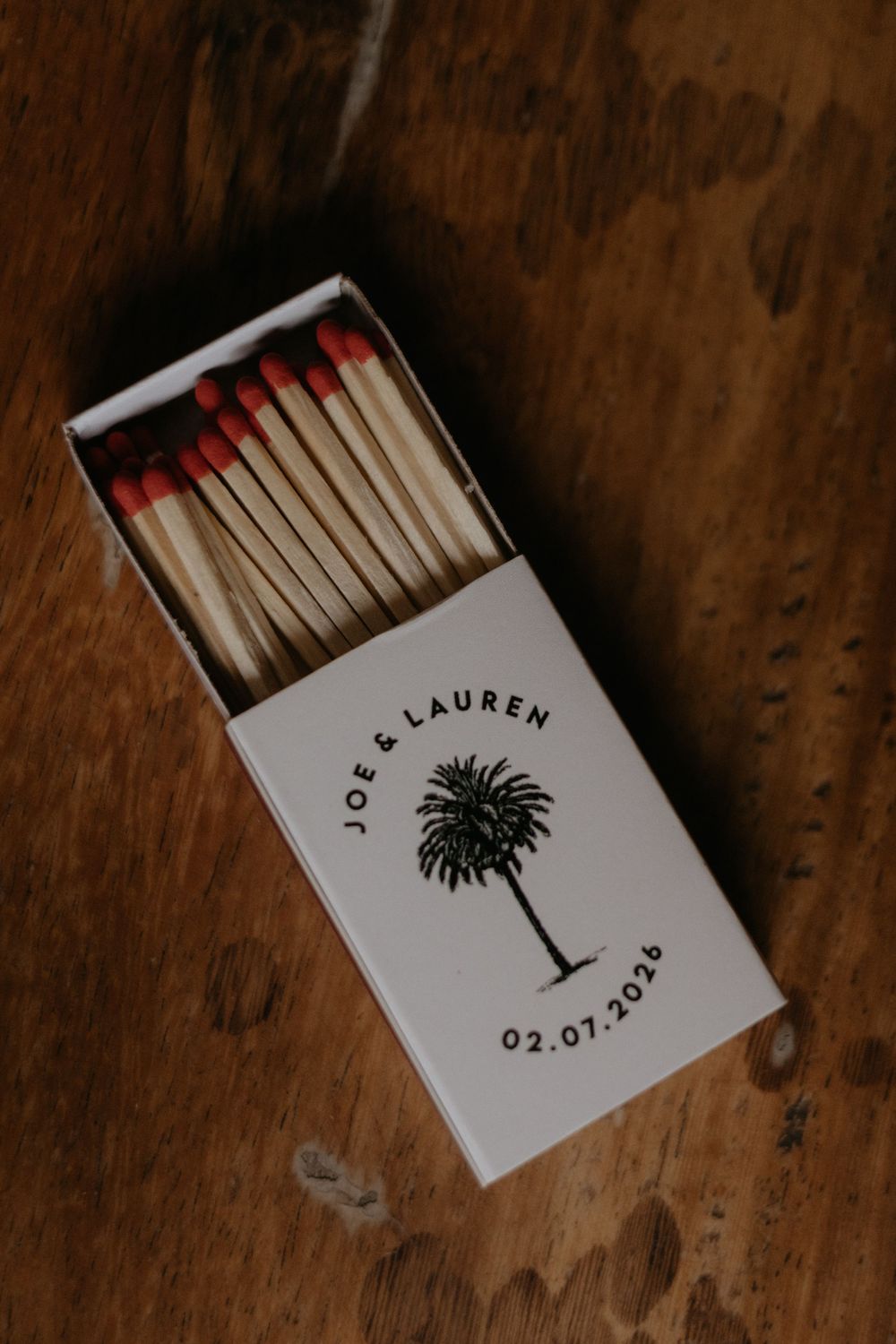 Custom wedding matchbox favor printed with palm tree design for Joe and Lauren dated 02.07.2026.