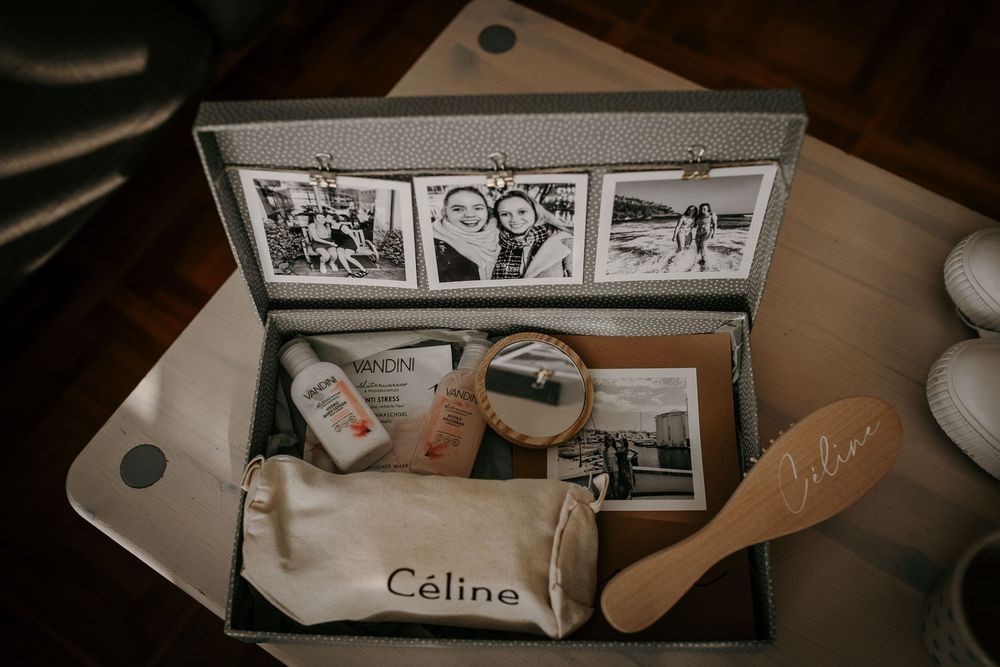 Personalized wedding gift box for Celine featuring black and white photo strips, beauty products, and a custom hairbrush.