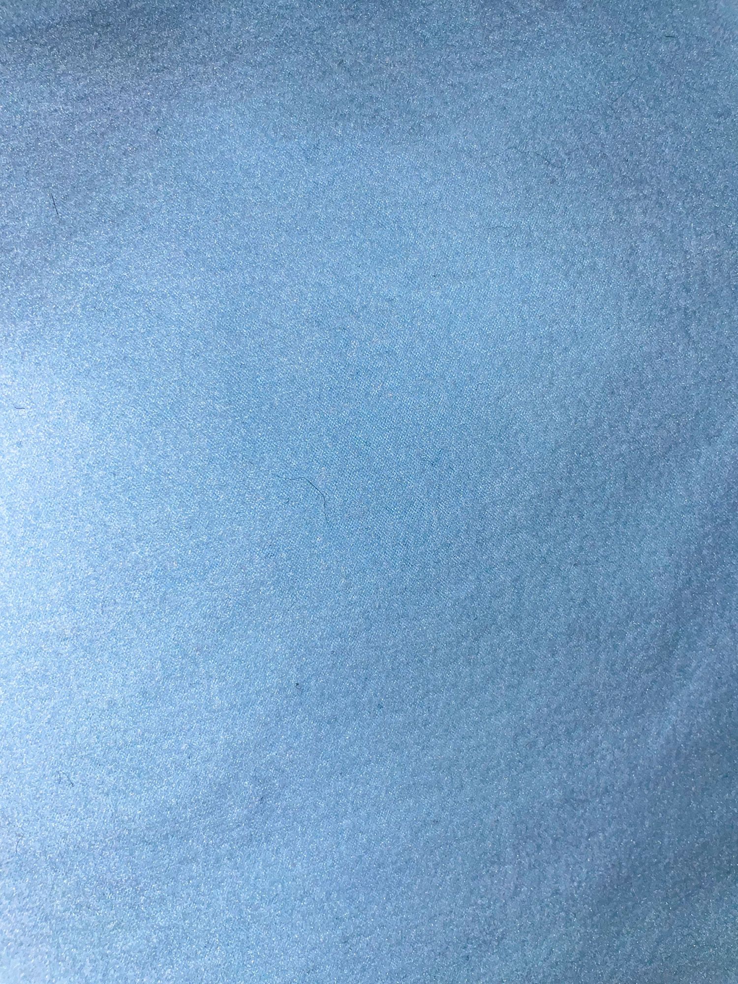 Solid blue textured background with smooth gradient effect.