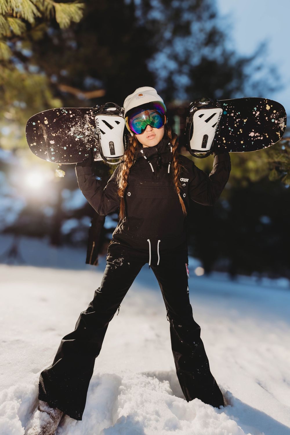Sequence of snowboarder performing dynamic tricks and jumps in fresh powder snow against bright winter sunlight.