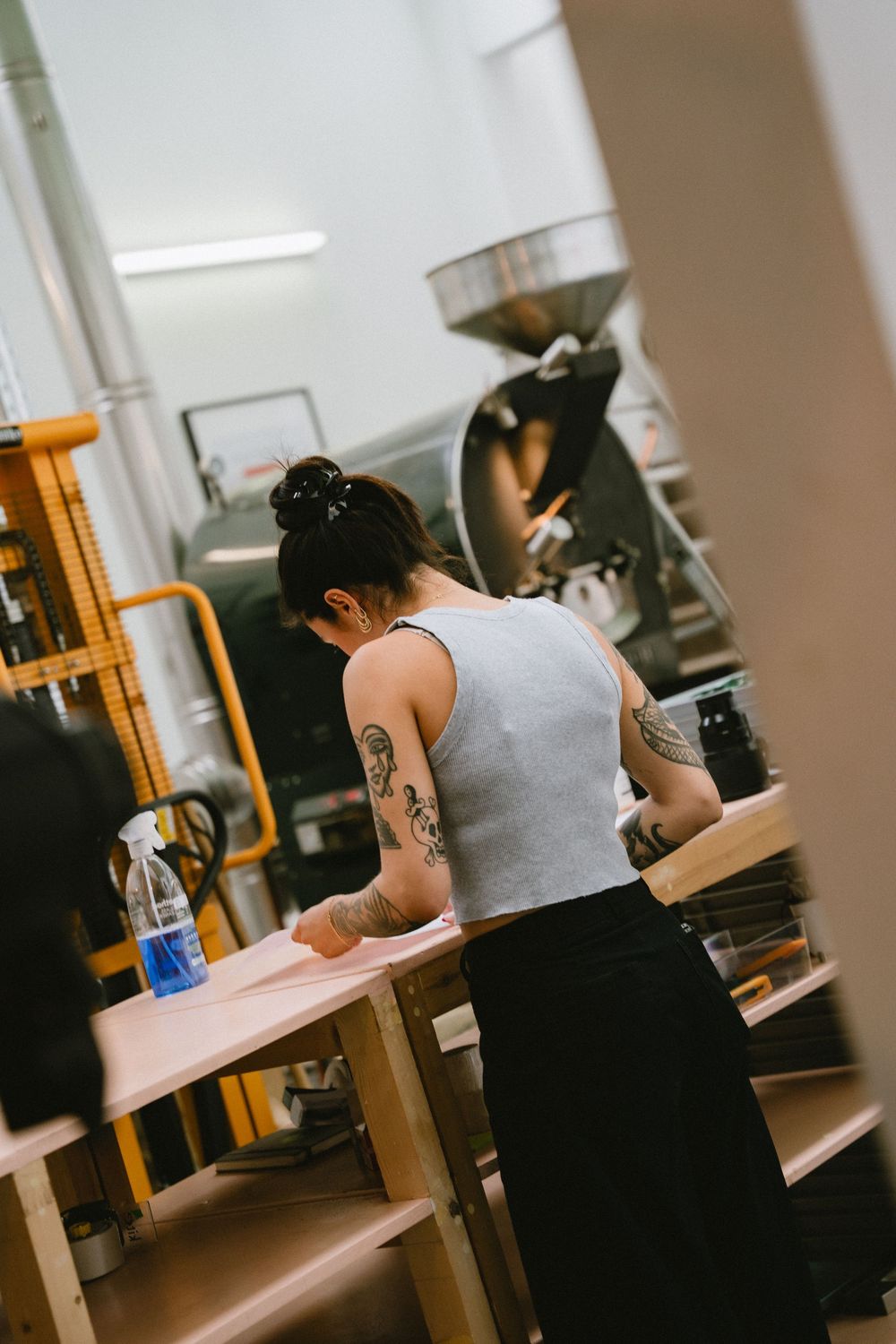 Lifestyle coffee photography in London showing a coffee roastery and a girl at work