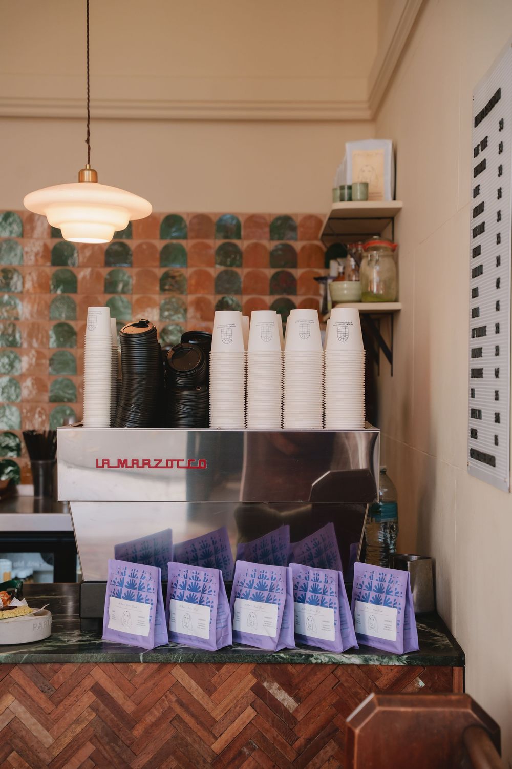 Lifestyle coffee photography in London showing a coffee machine and front counter inside of a cafe in Hammersmith
