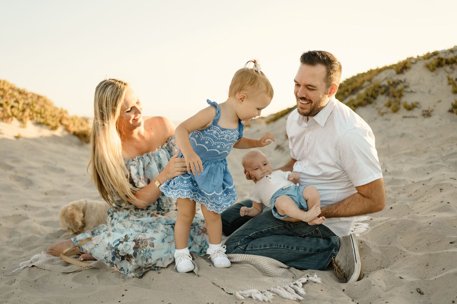 A family enjoying time together on a sandy beach.