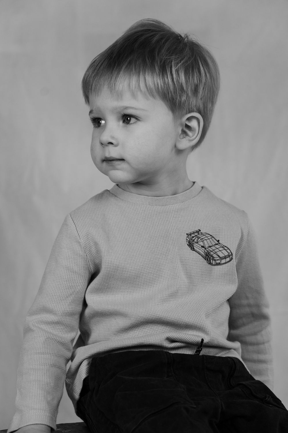 Small boy in a studio in black and white.