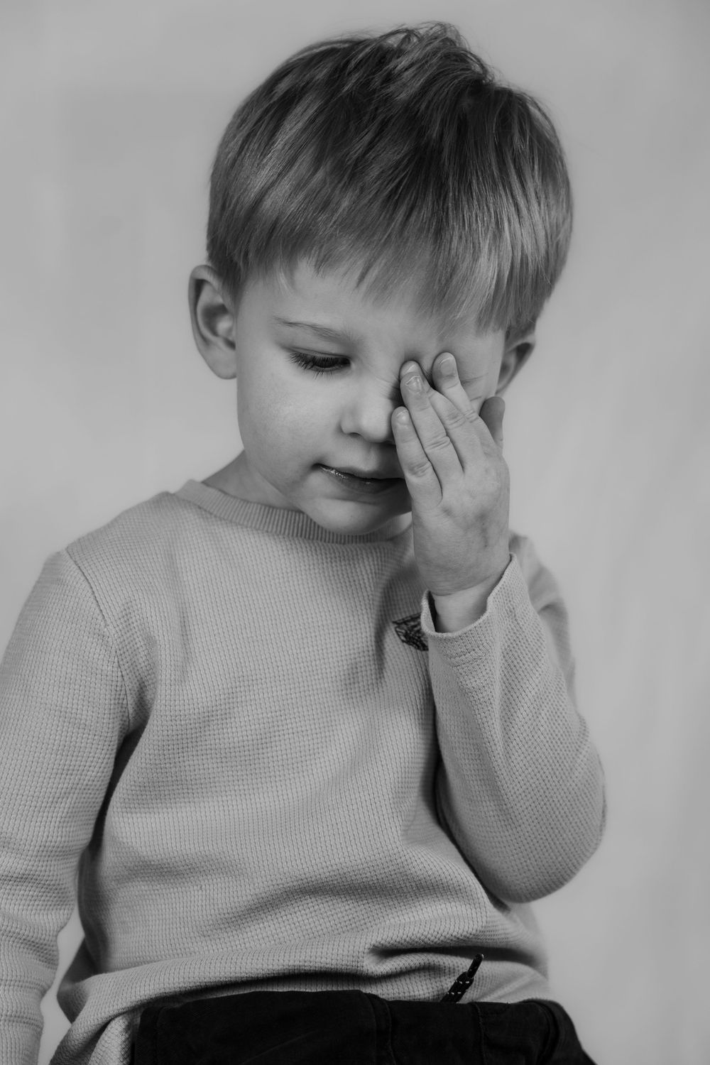 Small boy in a studio in black and white.