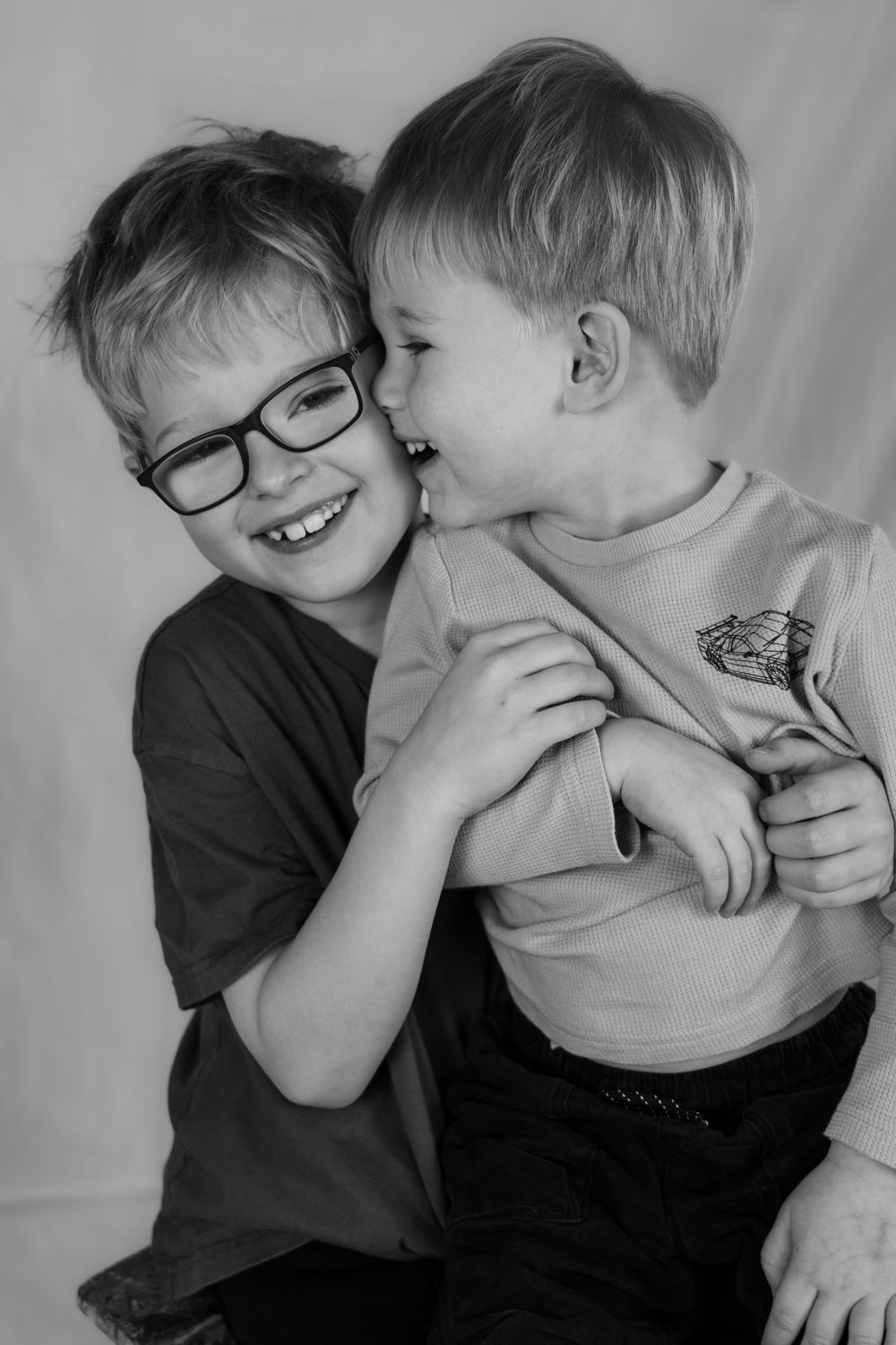Brothers having fun in a studio shoot, black and white photograph.