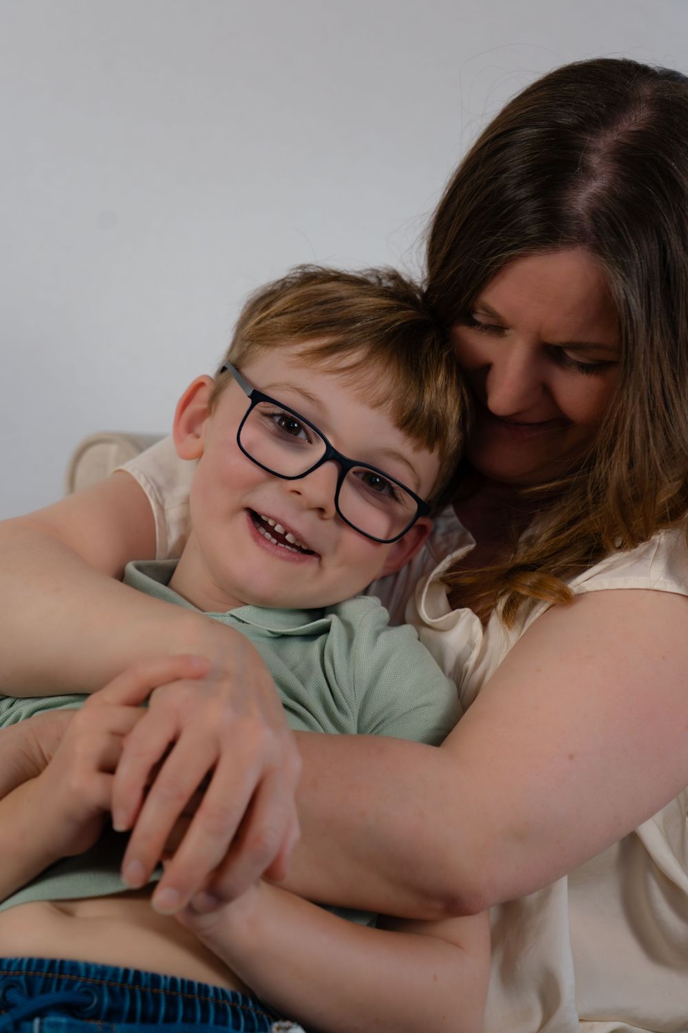 A mum giving her youngest son a hug