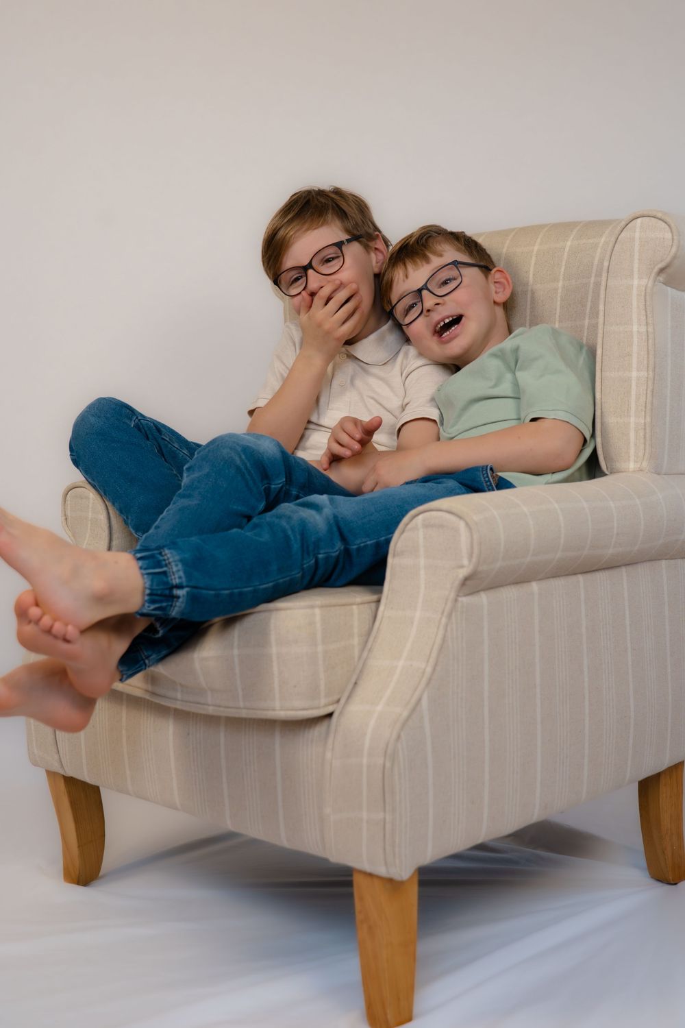 Brothers laughing at mummy during a studio photoshoot.